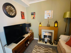 A single-bed room with a guest lounge